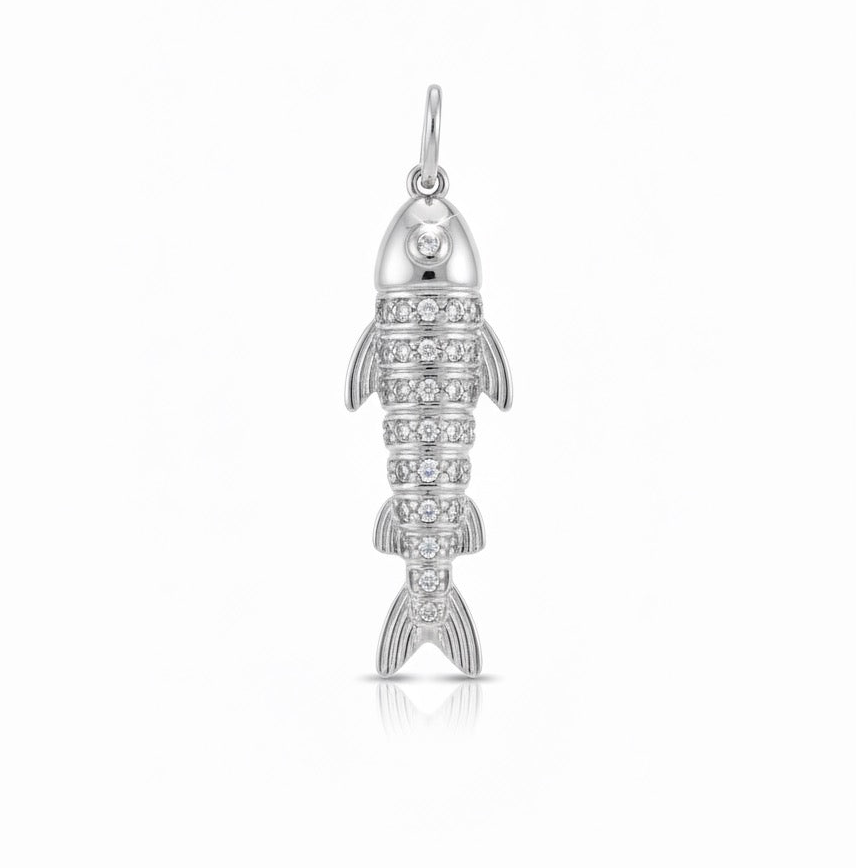 Silver fish-shaped pendant with embedded stones on a white background